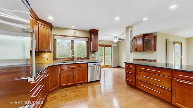 17N560 Hidden Hills Trl, Dundee, IL 60118 - kitchen featuring a peninsula, wall chimney range hood, tasteful backsplash, light wood-style flooring, and high end appliances
