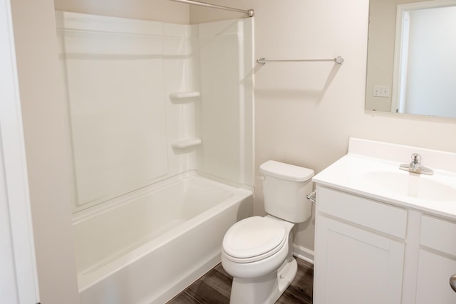 bathroom with bathtub / shower combination, toilet, vanity, and wood finished floors