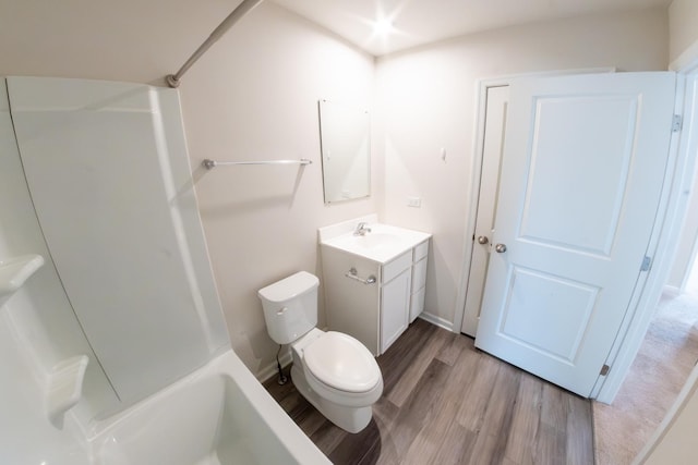full bath featuring baseboards, toilet, vanity, and wood finished floors