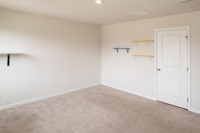 carpeted spare room with baseboards, visible vents, and recessed lighting