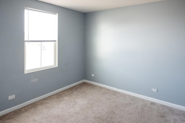 spare room with carpet flooring and baseboards