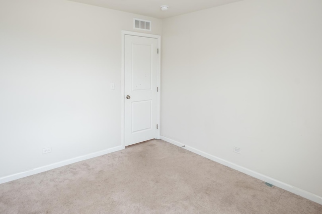 carpeted spare room with baseboards and visible vents