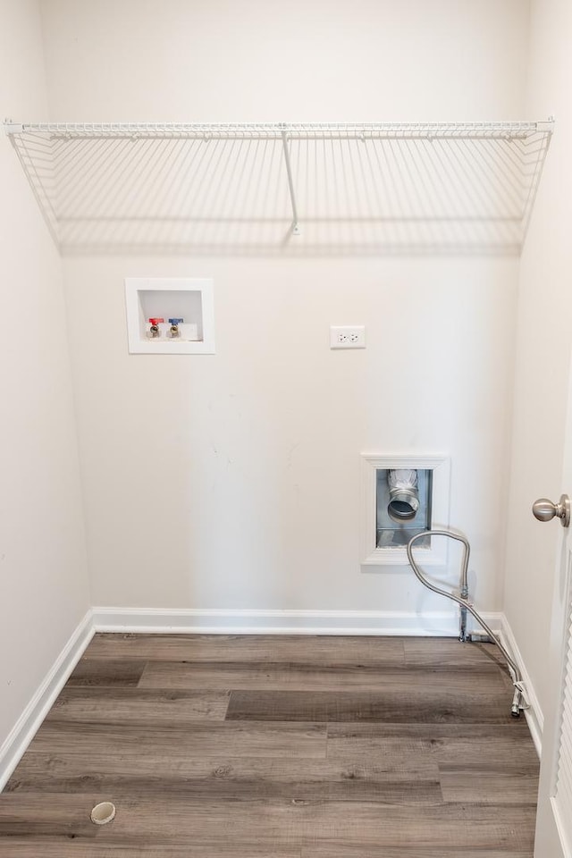 laundry area featuring wood finished floors, baseboards, laundry area, and washer hookup