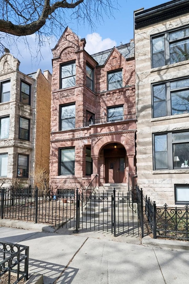 view of building exterior featuring a fenced front yard