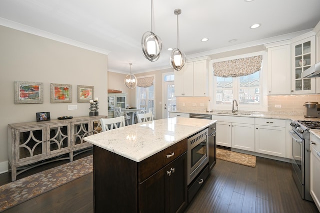 kitchen featuring crown molding, white cabinetry, and stainless steel appliances