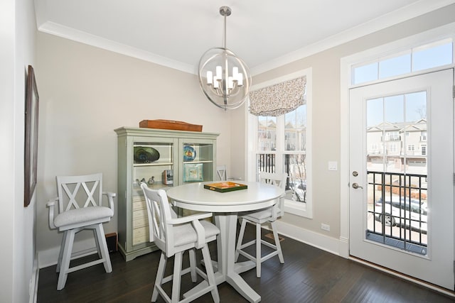 dining area featuring baseboards, a notable chandelier, dark wood-style flooring, and crown molding