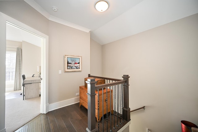 staircase with baseboards, vaulted ceiling, and wood finished floors