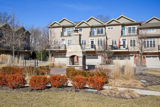 view of front of property featuring a garage and stone siding