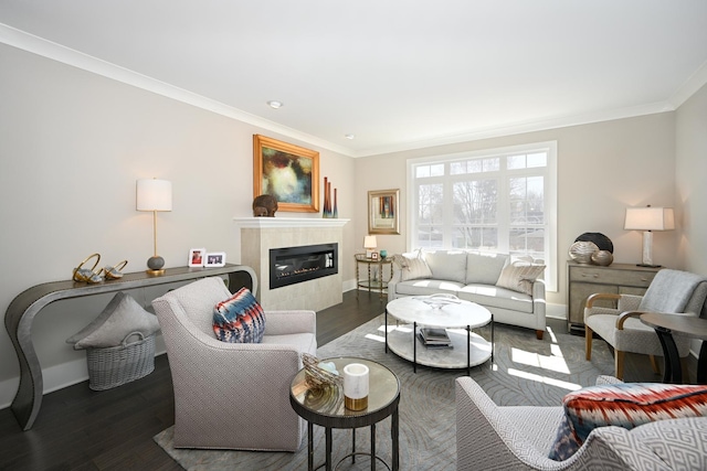 living room with dark wood-style flooring, ornamental molding, baseboards, and a tile fireplace