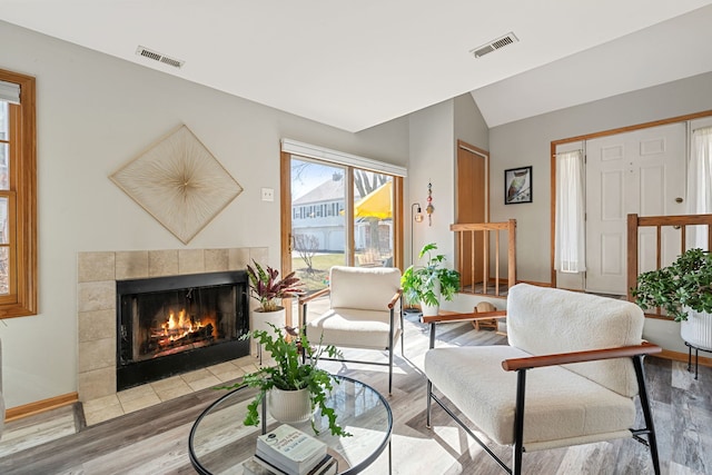 2S723 Timber Dr, Warrenville, IL 60555 - living area featuring a tiled fireplace, visible vents, and light wood finished floors