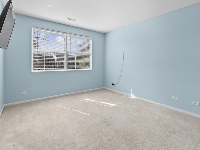 unfurnished room with visible vents, carpet flooring, and baseboards