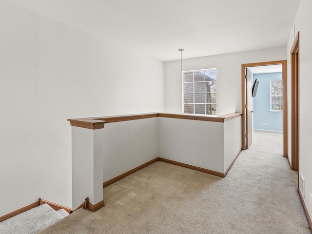 hall featuring carpet floors and baseboards