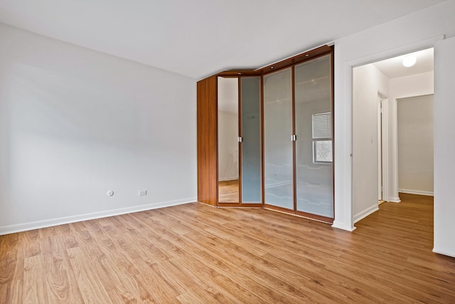 2275 Country Club Dr Unit 24, Woodridge, IL 60517 - unfurnished bedroom featuring light wood finished floors, baseboards, and a closet