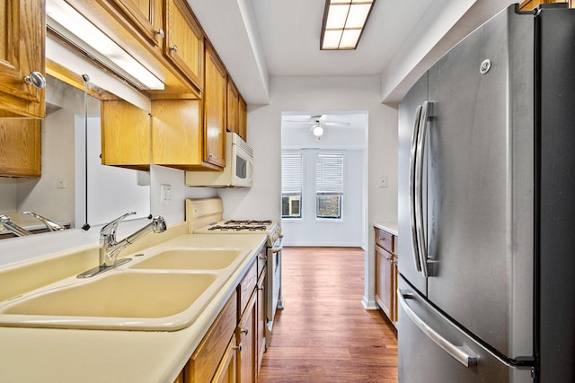 2275 Country Club Dr Unit 24, Woodridge, IL 60517 - kitchen with white appliances, dark wood-type flooring, a sink, brown cabinetry, and a ceiling fan