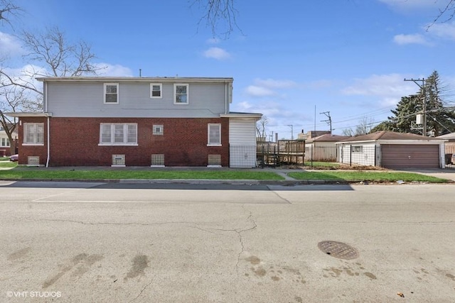 back of property featuring an outbuilding and brick siding