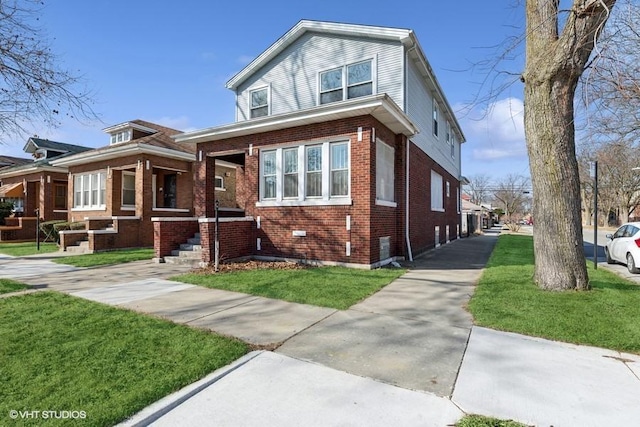 view of front of house featuring brick siding and a front lawn