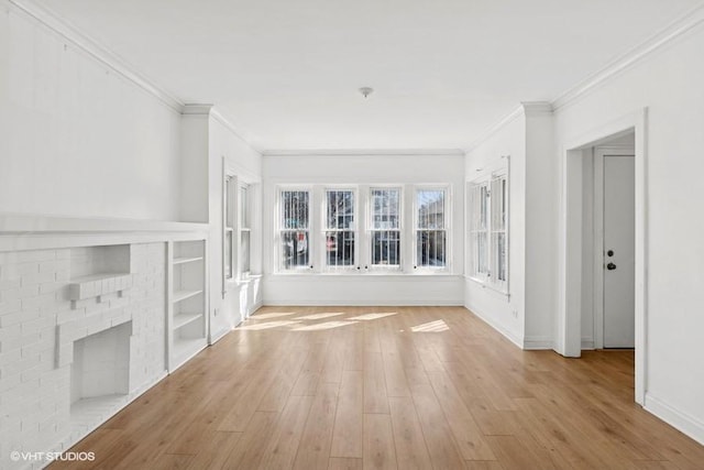 unfurnished living room with crown molding, built in features, wood finished floors, and baseboards