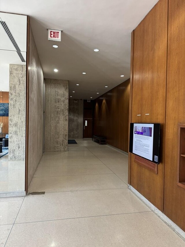 corridor featuring recessed lighting and light speckled floor