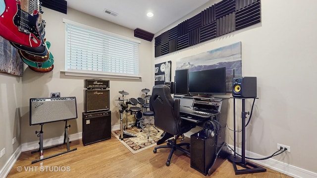 office featuring baseboards, visible vents, and wood finished floors