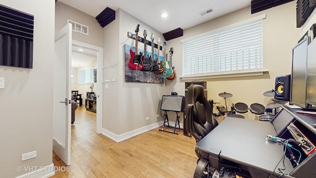 office space with recessed lighting, baseboards, visible vents, and wood finished floors