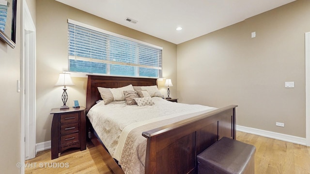 bedroom with baseboards, recessed lighting, light wood-style flooring, and visible vents
