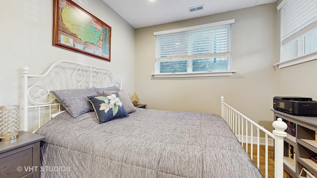 bedroom with visible vents and wood finished floors