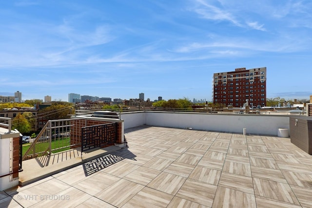 view of patio / terrace featuring a view of city and a balcony