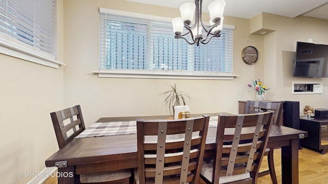 dining area featuring an inviting chandelier and wood finished floors