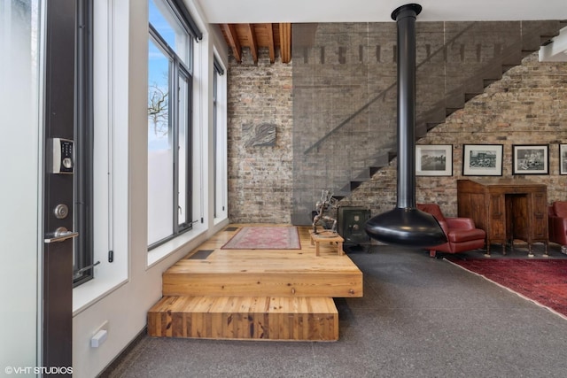 1825 W Wabansia Ave, Chicago, IL 60622 - interior space featuring brick wall, a wood stove, and carpet flooring