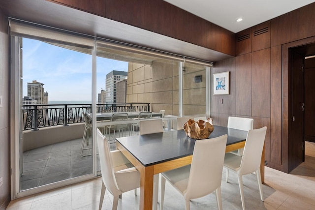 dining space with a city view and light tile patterned floors