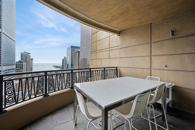 balcony with a water view and a view of city