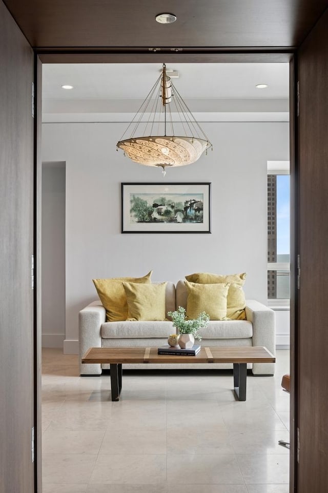living area featuring baseboards