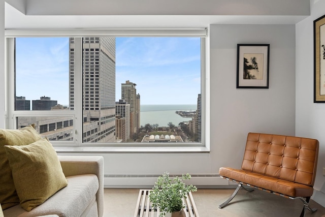 sitting room with a water view and a view of city