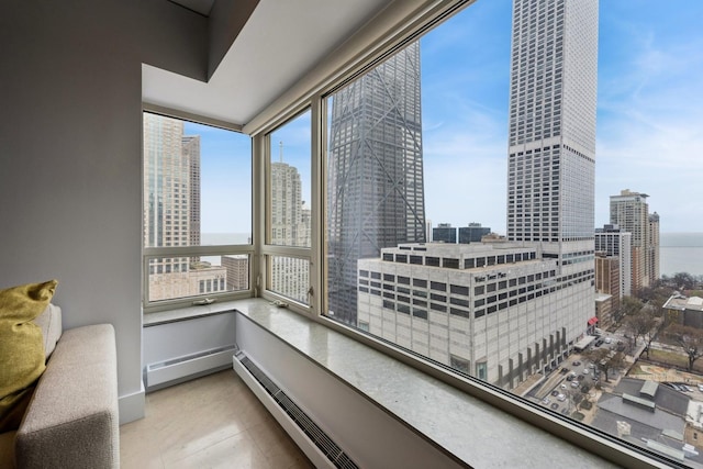 interior space featuring a baseboard radiator and a view of city