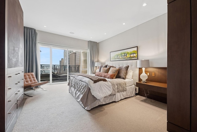 carpeted bedroom featuring access to exterior and recessed lighting
