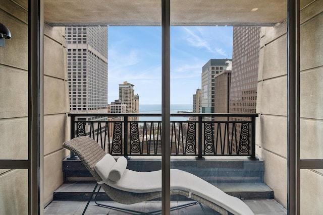 balcony with a water view and a city view