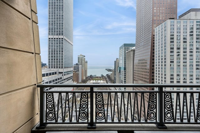 balcony featuring a view of city and a water view