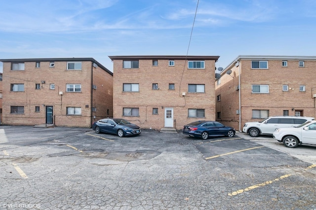 view of building exterior featuring uncovered parking
