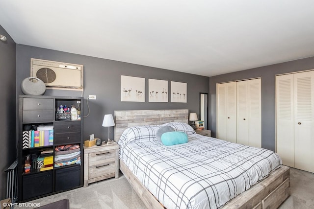 bedroom with carpet and two closets