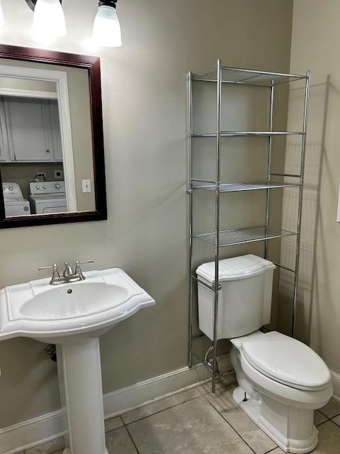 986 Rossmere Ct, Naperville, IL 60540 - half bath with independent washer and dryer, toilet, baseboards, and tile patterned floors