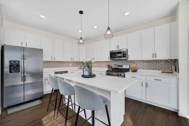 1705 Kraft Ave, Batavia, IL 60510 - kitchen with light countertops, white cabinetry, a kitchen bar, and stainless steel appliances