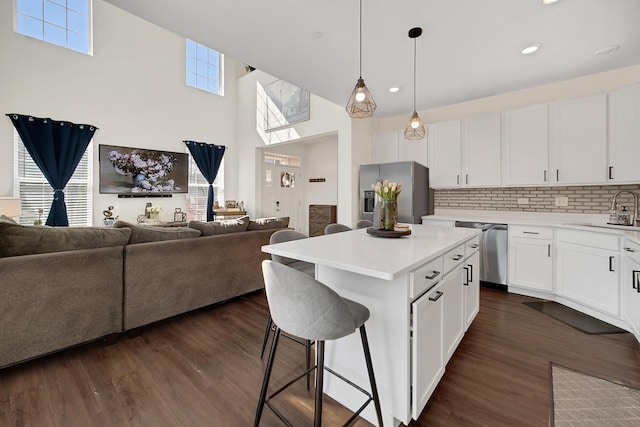 1705 Kraft Ave, Batavia, IL 60510 - kitchen with a sink, open floor plan, light countertops, a breakfast bar, and stainless steel appliances