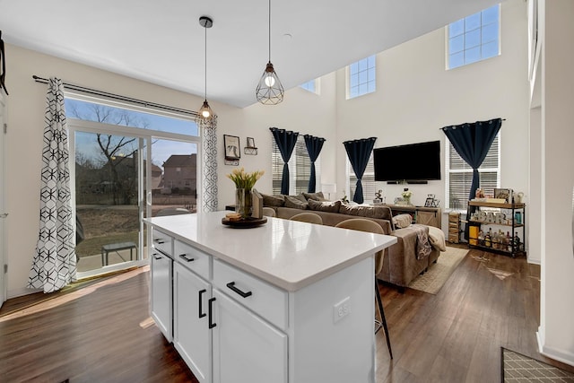 1705 Kraft Ave, Batavia, IL 60510 - kitchen featuring a kitchen breakfast bar, dark wood-type flooring, white cabinets, a center island, and light countertops
