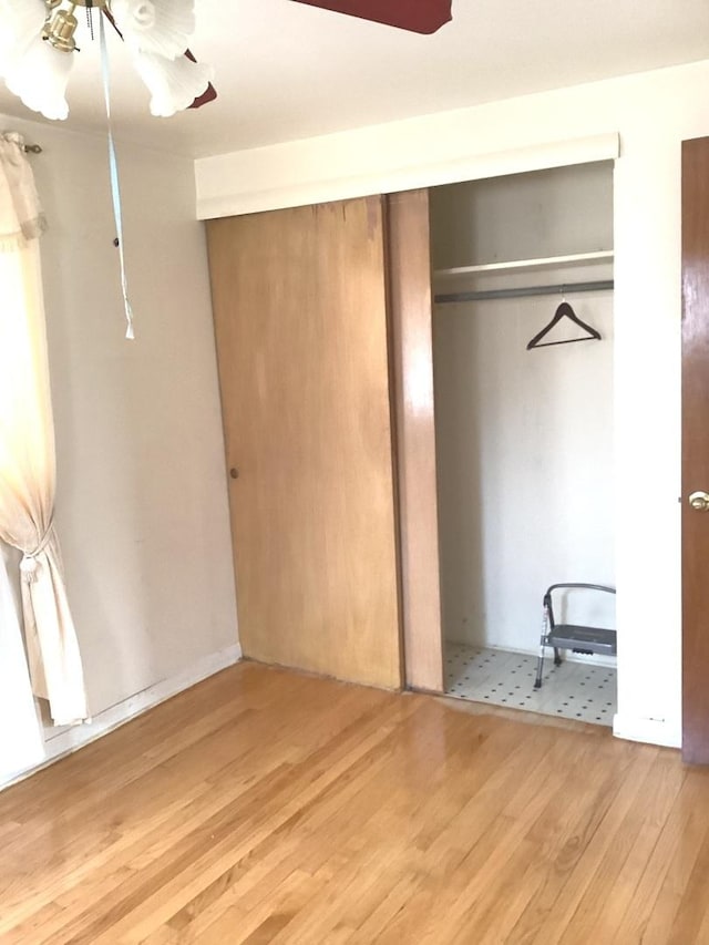 unfurnished bedroom featuring a closet and wood finished floors