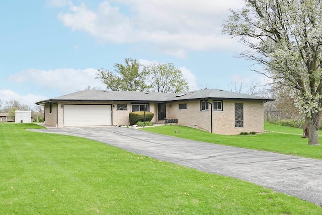 ranch-style home with an attached garage, a front lawn, aphalt driveway, and brick siding