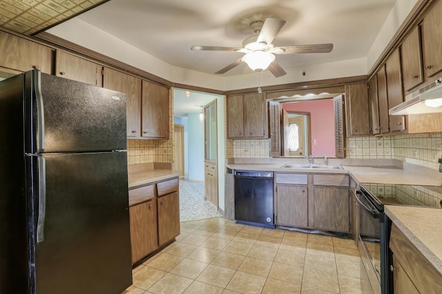kitchen with ceiling fan, a sink, light countertops, black appliances, and under cabinet range hood