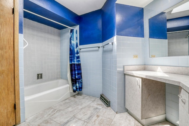bathroom featuring tile walls, vanity, and shower / bath combination with curtain