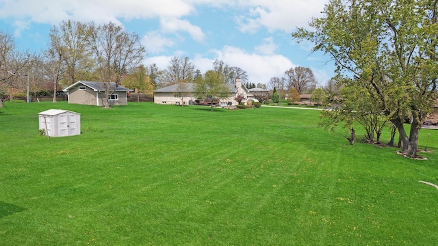 view of yard featuring an outbuilding and a shed