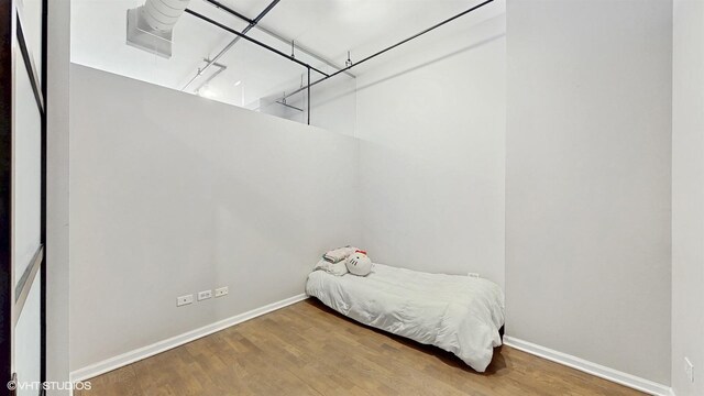 400 W Ontario St Unit 606, Chicago, IL 60654 - bedroom featuring baseboards and wood finished floors