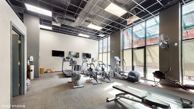 400 W Ontario St Unit 606, Chicago, IL 60654 - workout area with a wall of windows, a towering ceiling, visible vents, and carpet floors